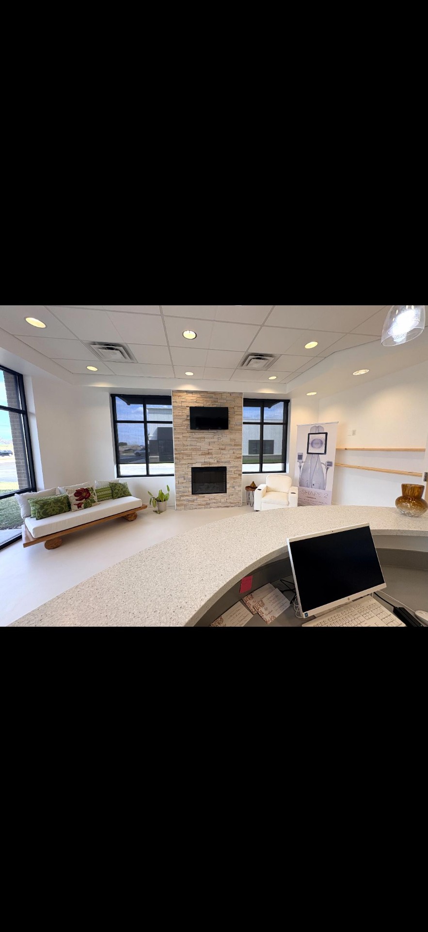 The Skin & Body Shop lounge with stone fireplace and natural light